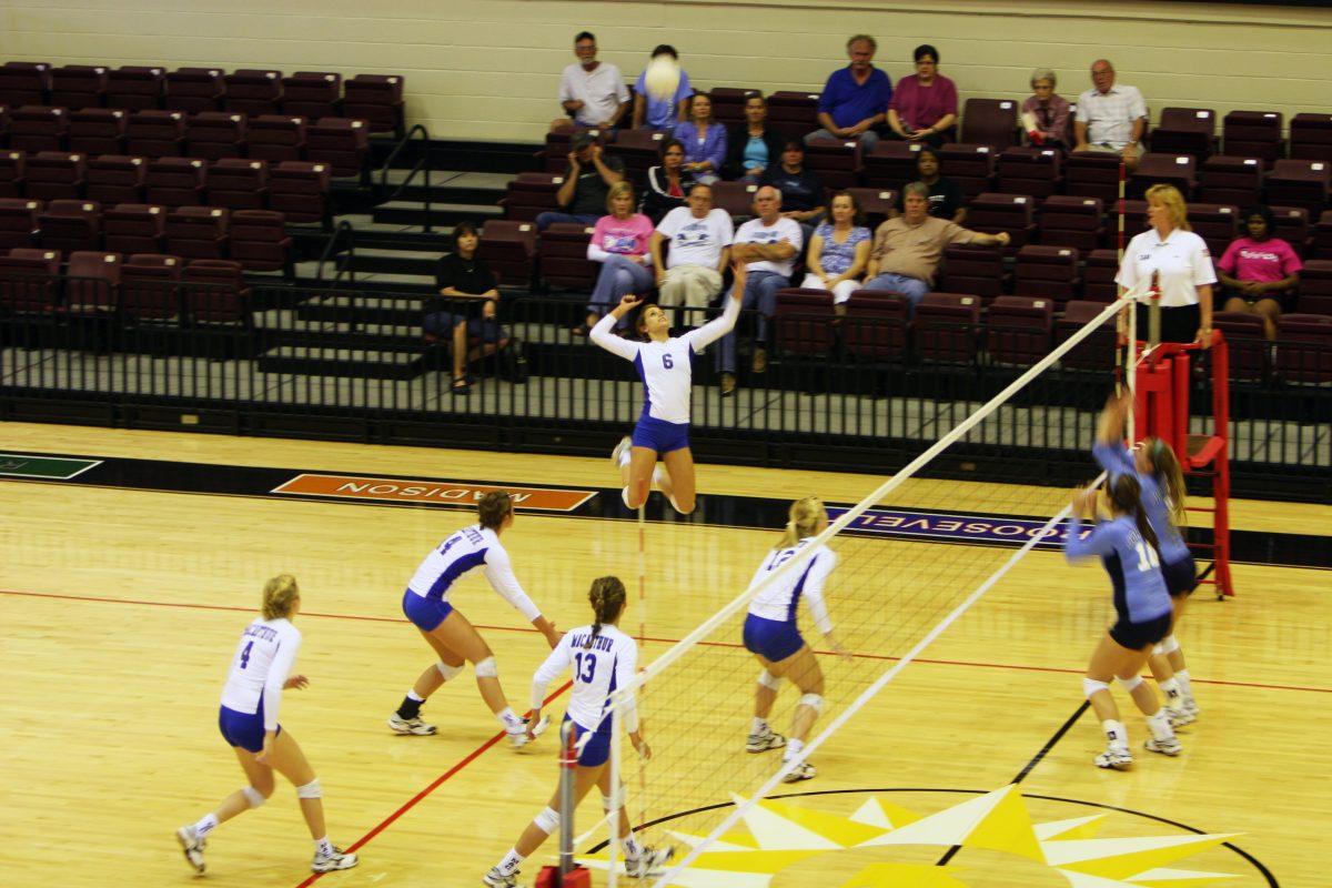 Tori Rodriguez spiking the volleyball