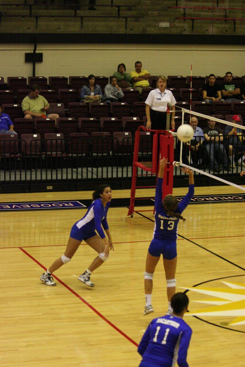 Haley Hamilton (12) sets Blake Johnson (12) up for the spike.