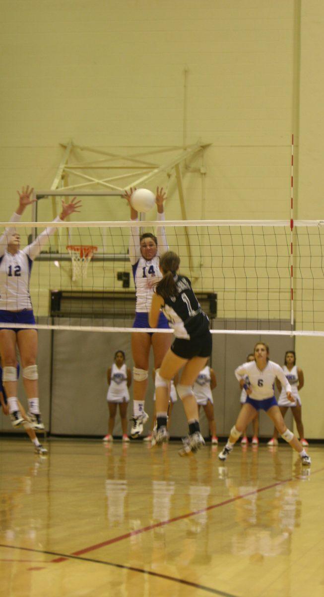 Kelsey Huber (12) blocks the oncoming ball.