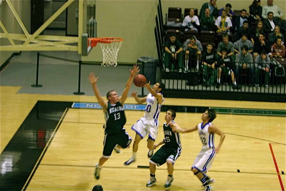 Michael Flores dives into the lane for a layup. Photo by Michael Robinson