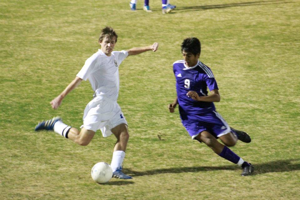 Justin Myers wins the ball from a Warren player, photo by Hannah Kurtz