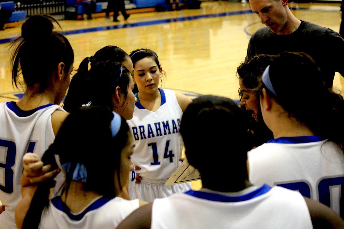 Varsity Basketball girls strategize during the Roosevelt game. photo by Meredith Collier