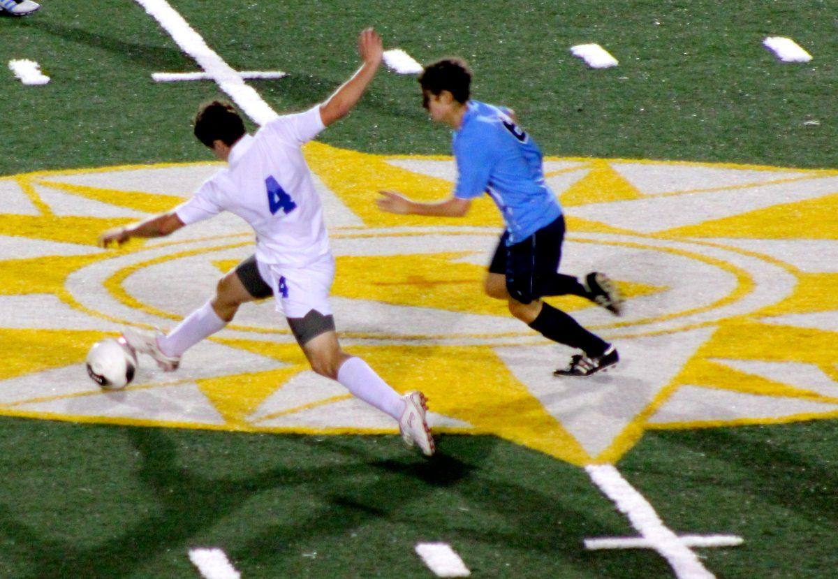 Harley Hill stretches his legs and pushes the ball past a Jag defender, photo by Renee Cornue