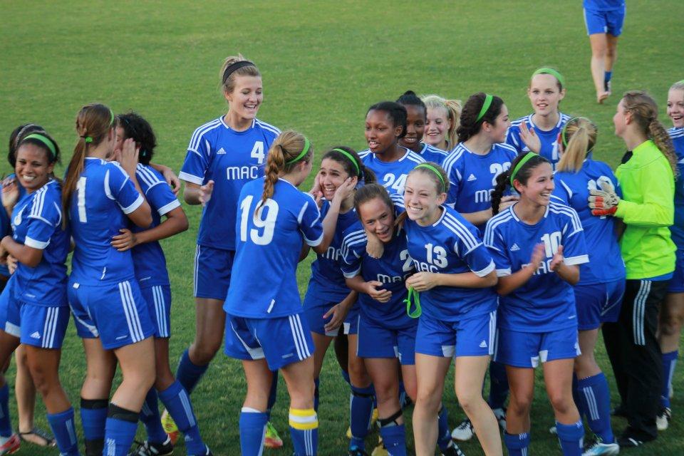 Mac soccer girl celebrate the win as they advance in playoffs. photo by Hannah Kurtz