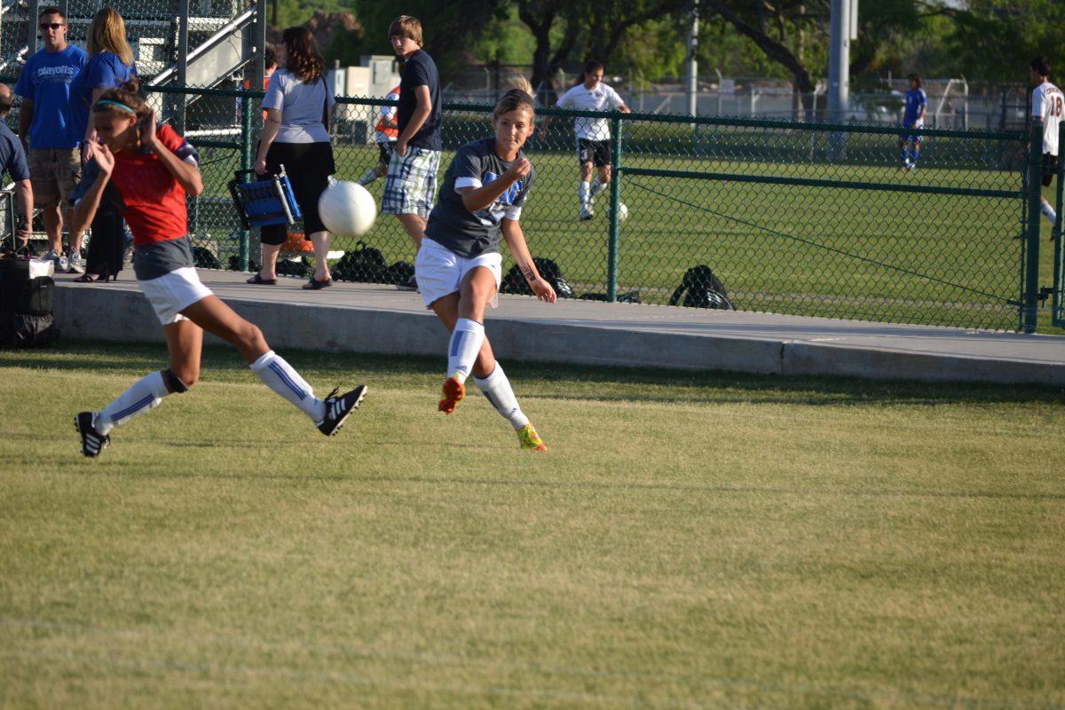 Shannon Lukehart (11) and Bridgette Evans (11) warm up before playing Judson. Photo by Sarah Morales 