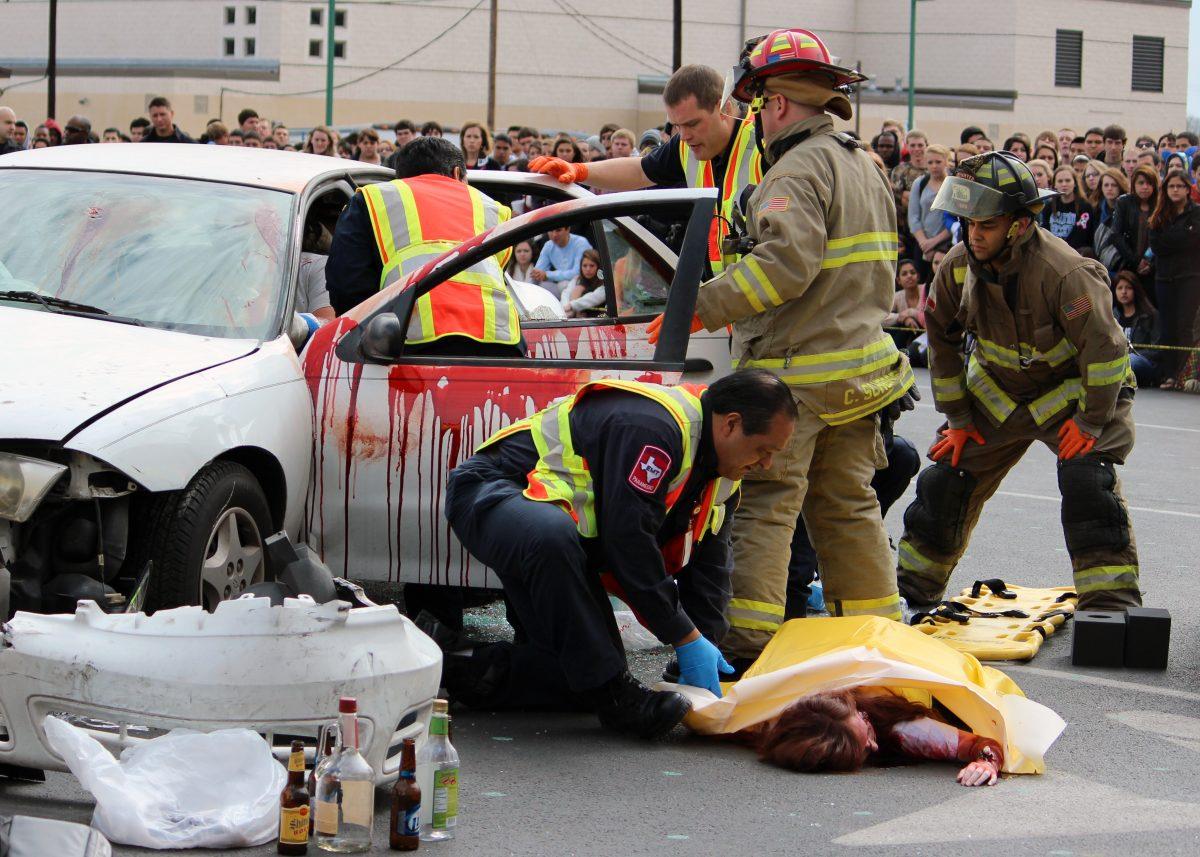 To demonstrate the effects of drinking and driving students participated in "Shattered Dreams". The exercise simulated a car accident that "killed" student Lexy Hanes (under the yellow tarp). Tomorrow students will attend a memorial service for the students that were "killed" in the simulation.
photo by Brittany Trub