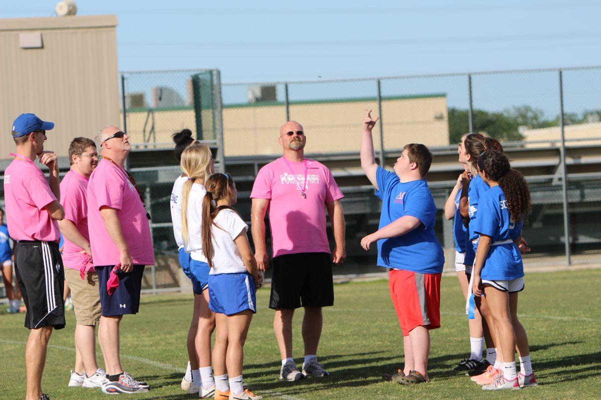 Collin at the center of the field doing the coin toss to see who gets the ball first.
Photo by:Kayla Martin