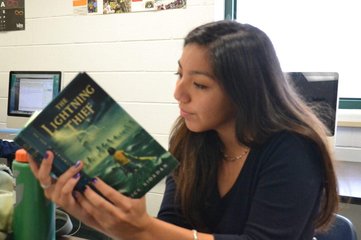 Valerie Lozano reading the Lightning Thief. Photo by Vanessa Ramirez