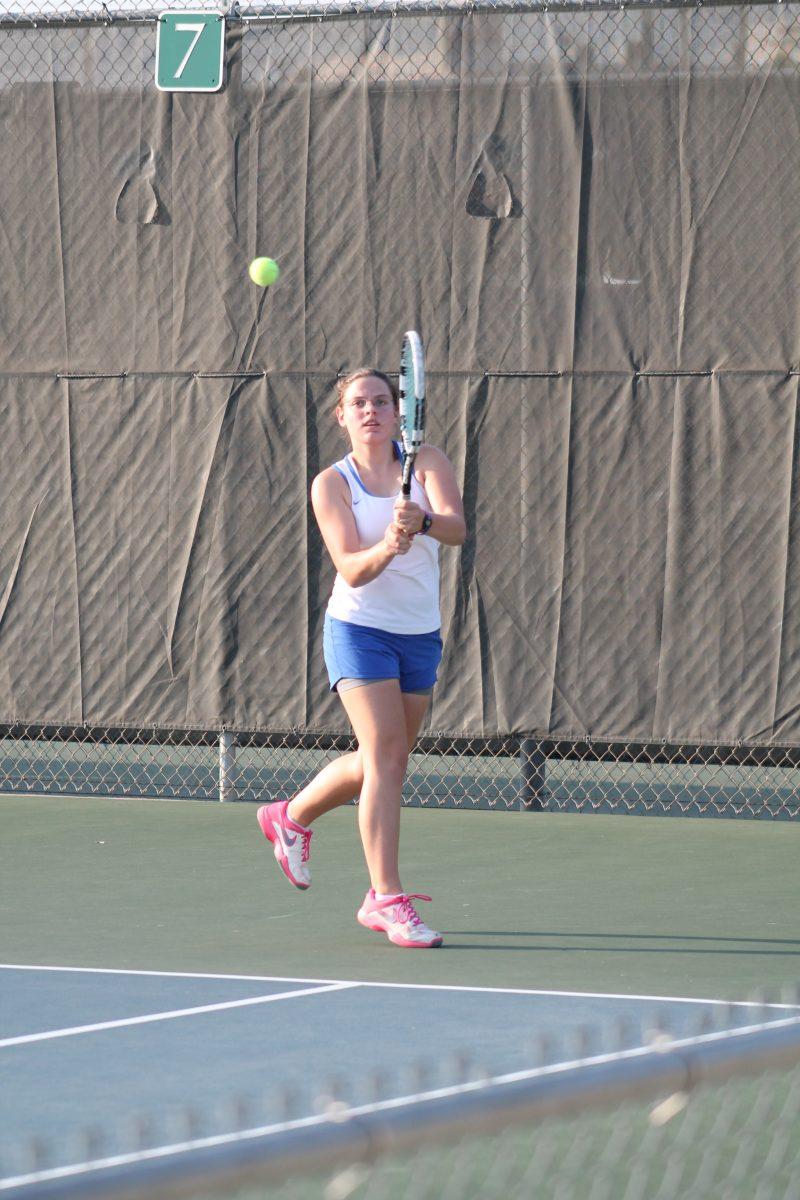 Junior Ann Marie Burns running to hit a ball.
Photo by India Nikotich