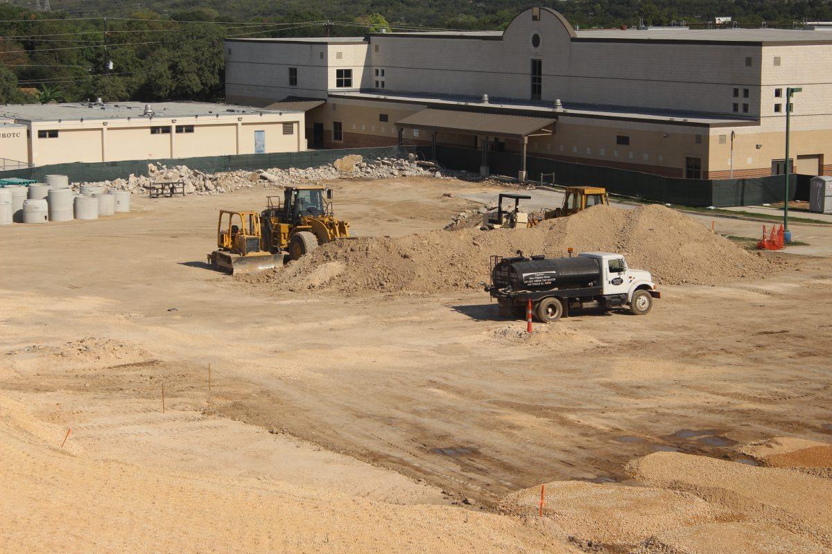 Workers move around on vehicles to transfer supplies.
Photo by Erin Shroeder