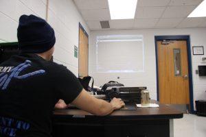 Senior Nathaniel Johnston scrolling through code. Photo by Kayla Gunn.