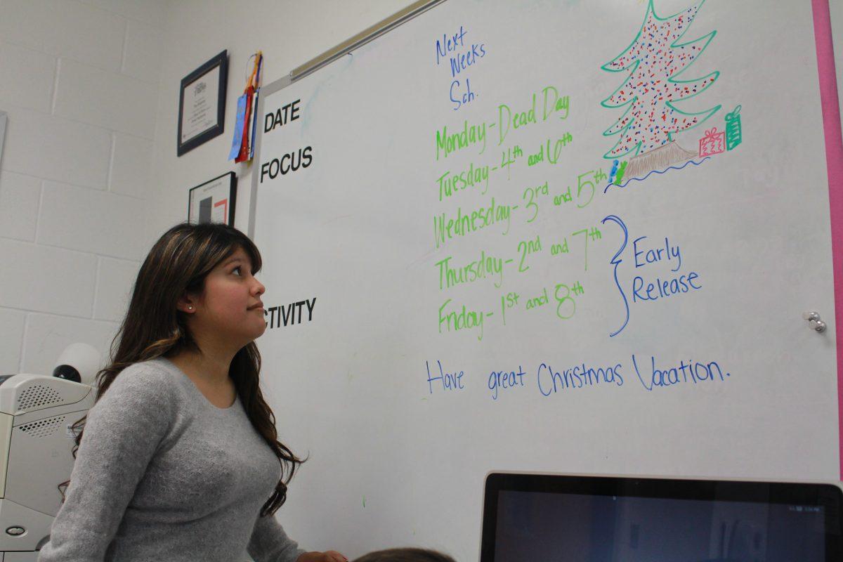 Senior Vanessa Ramirez checking out the dates of the exams this week. Photo by Kayla Gunn