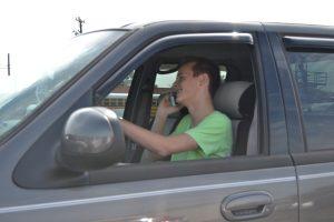 Justin driving while on the phone. Photo by Vanessa Ramirez 