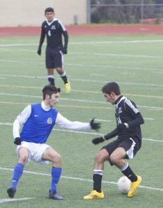 Senior forward Nico Plumas fights for the ball. Photo by Jacob Dukes