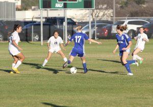 Senior midfielder Leslie Giles, in th face of three defenders, passes the ball to an open teammate. Photo by Jacob Dukes