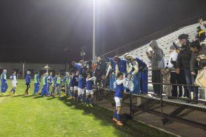 Players and fans celebrate the nerve racking win. Photo by Jacob Dukes