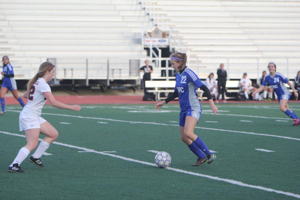 Kyra Falcone prepares to strike against a Churchill defender.
Photo by Jacob Dukes