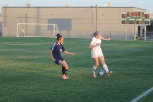 Senior Sydney Anderson dribbles past a Roosevelt defender. Photo by Jacob Dukes