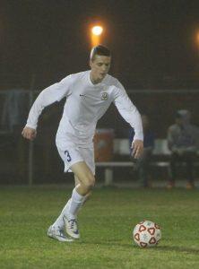 Senior Jake Piechota prepares to pass the ball down the field. Photo by Jacob Dukes