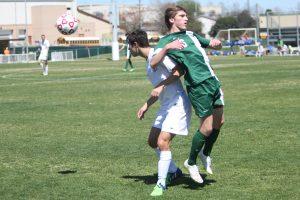 Senior Parker Miller battles a Reagan defender for position. Photo by Jacob Dukes