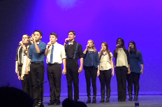 PFC singing on stage at Madison High School. Photo by: Stephanie Smith