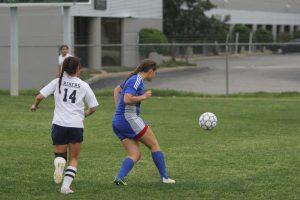 Junior Mary Cardone passing the ball. Photo by Jacob Dukes