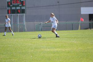 Sophomore Carly Norment taking the ball up the field. Photo by Jacob Dukes