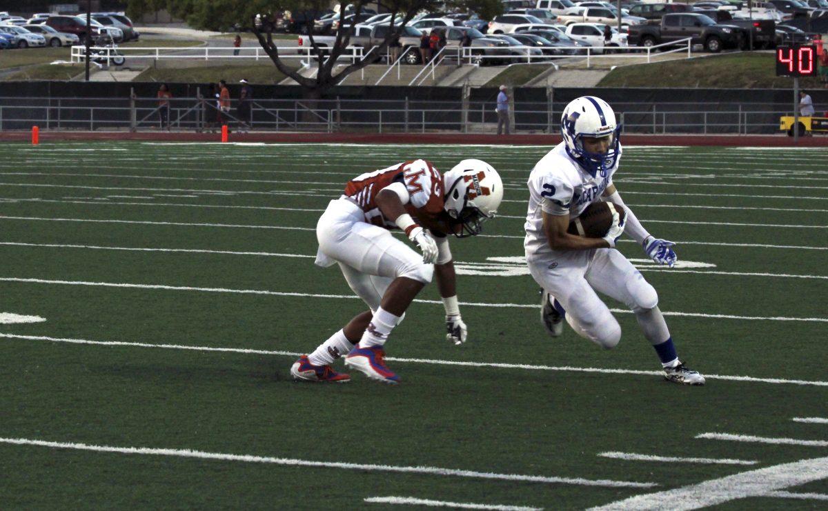 Wide receiver Nate Vega (12) avoids the Madison defense during the 2nd quarter of the game. The team lead by as many as 21 points. photo by Cardoza