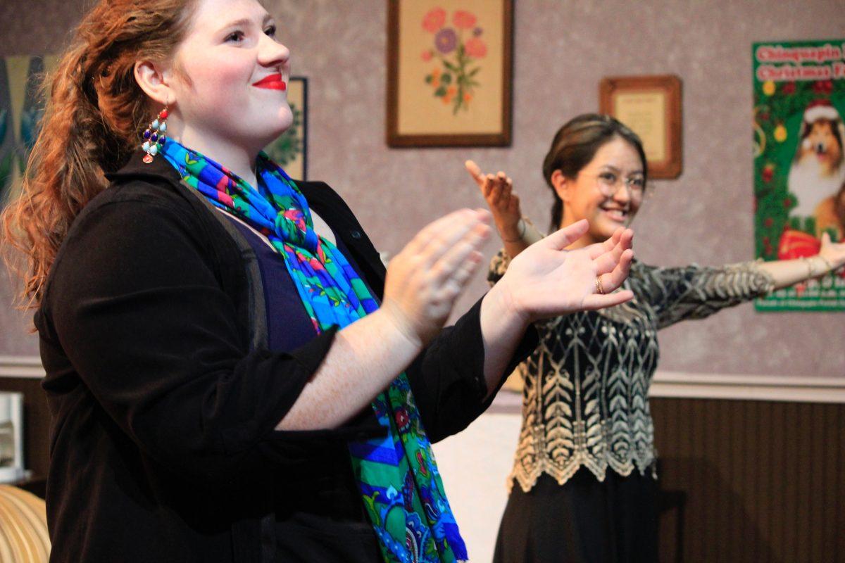 Lily Dunlap and Andrea Ayala clapping and smiling to the audience.