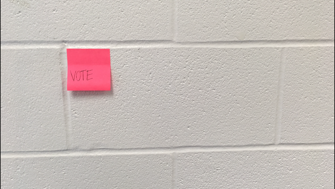 Sticky note reading 'vote.'  Photo by Mary DeLeon