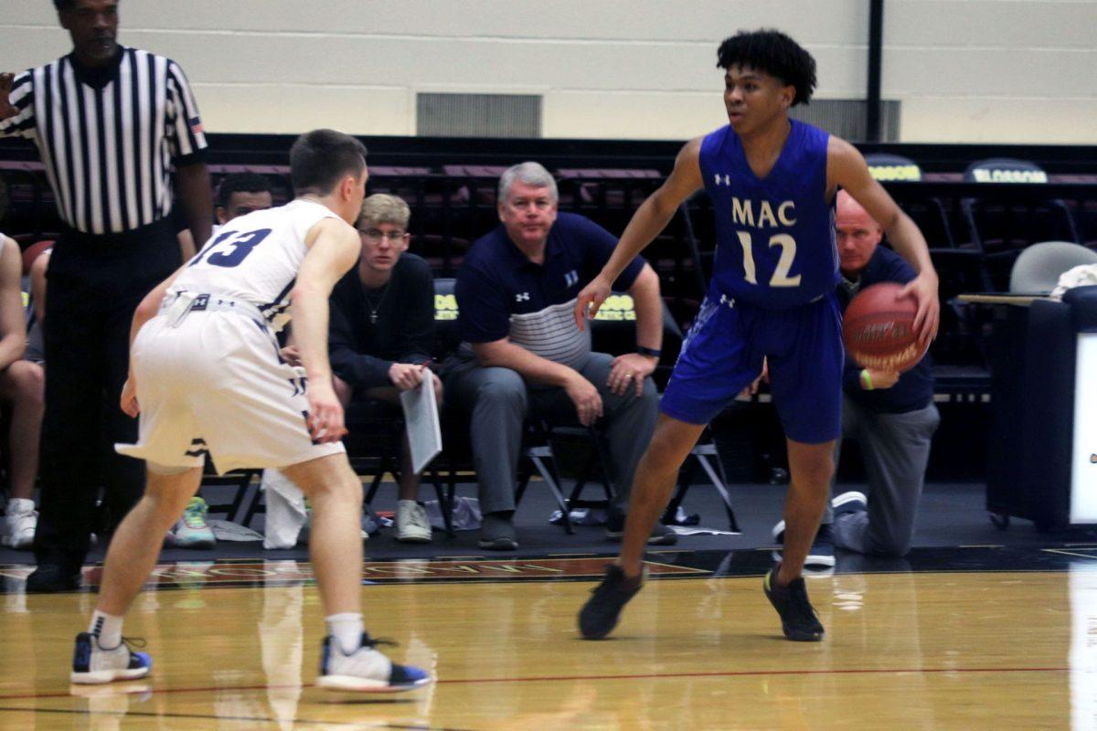 Leander Thompson, senior, dribbles the ball past the defender at Blossom Athletic Center against Johnson High School. 