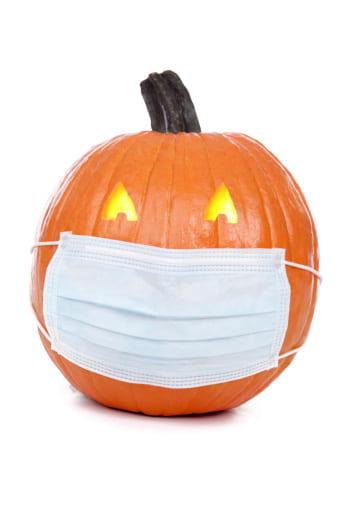 A jack-o-lantern wearing a medical mask.