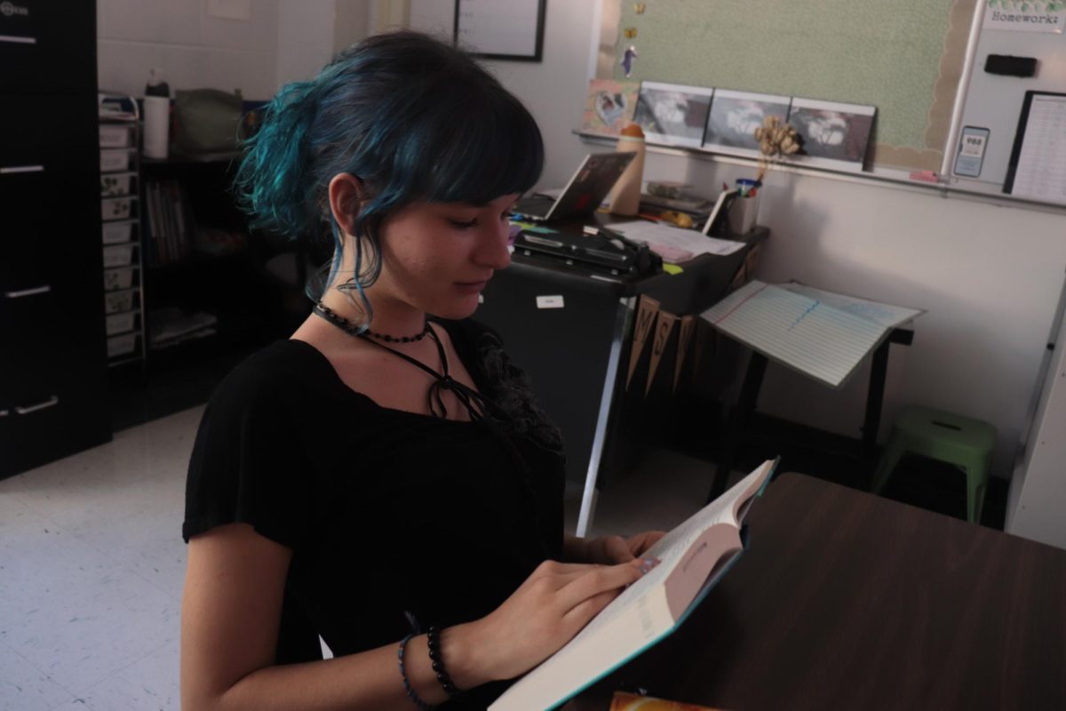 Alayna Sorenson reading a book in Shelf Love Book Club